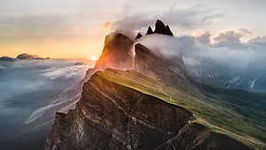 Dolomites Mountain Peaks Rising Above Clouds at Golden Hour in Italy HD wallpaper