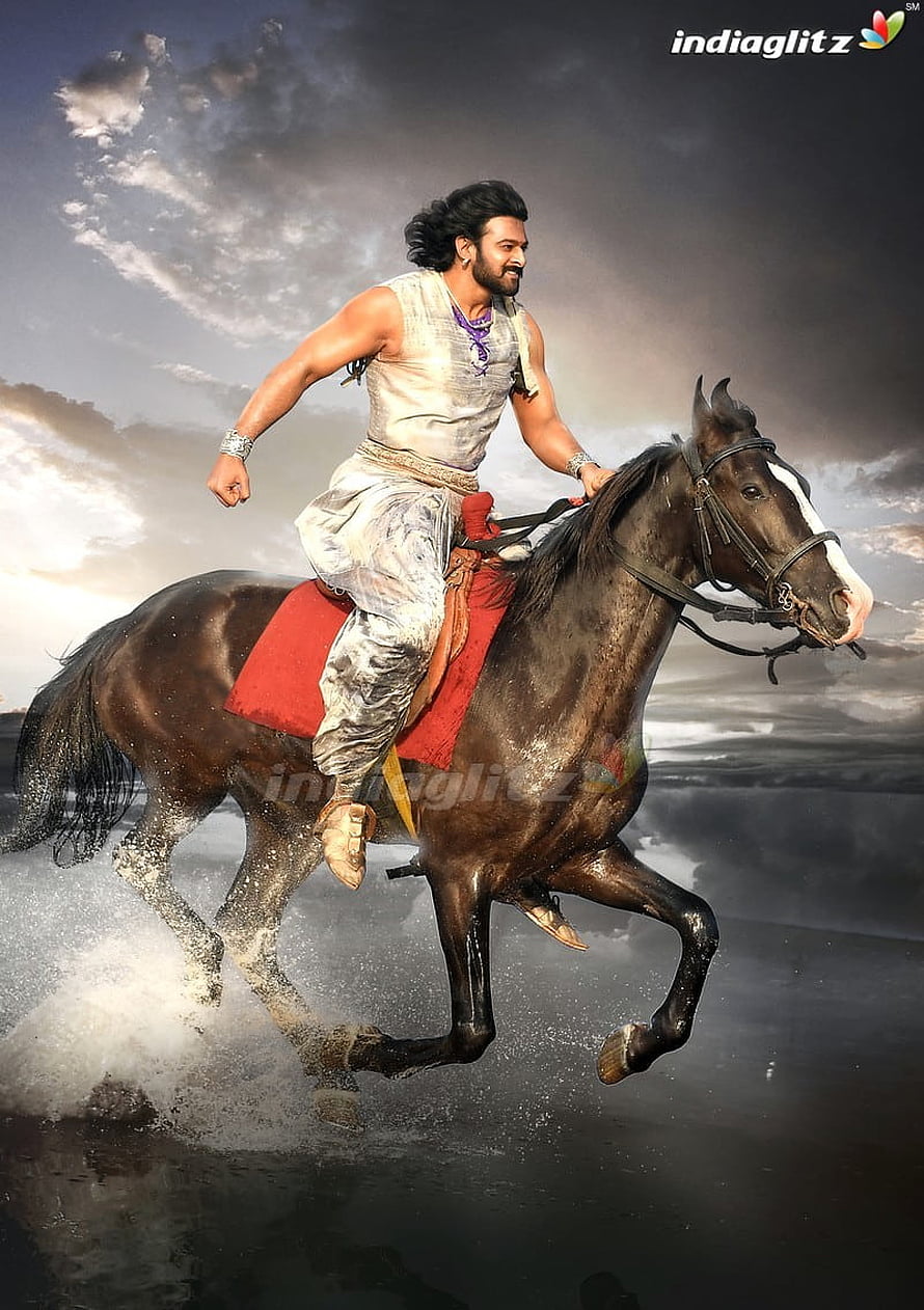 Prabhas as Baahubali riding a galloping horse through water in dramatic cinematic still HD phone wallpaper