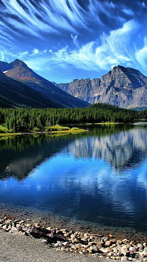 Serene Mountain Lake with Perfect Reflections and Pine Forest Under a Blue Sky HD phone wallpaper