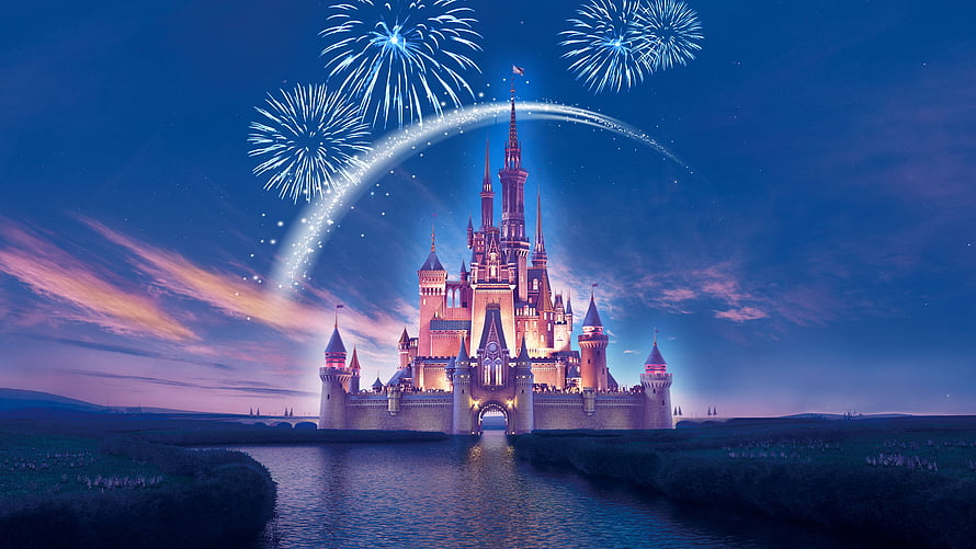 Disneyland Castle at Night with Fireworks and a Glowing Arc Over a Reflective Moat HD wallpaper