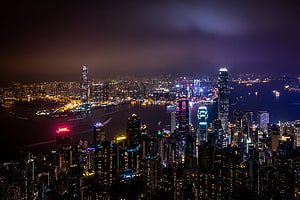 Aerial Night View of Hong Kong Skyline with Victoria Harbour and Illuminated Skyscrapers HD wallpaper
