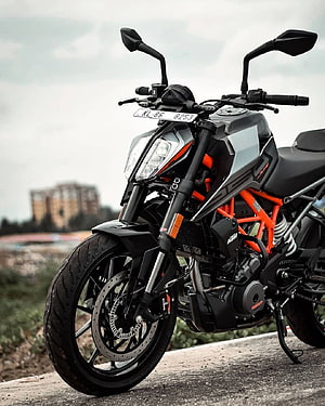 KTM Duke 250 Black and Orange Naked Motorcycle Parked on Concrete Surface HD phone wallpaper