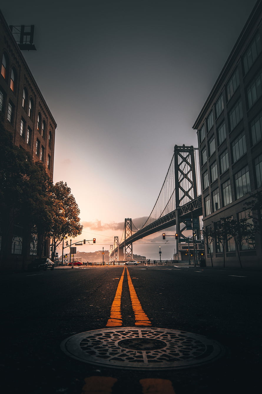 San Francisco Bay Bridge at Sunset with City Street and Yellow Road Lines HD phone wallpaper