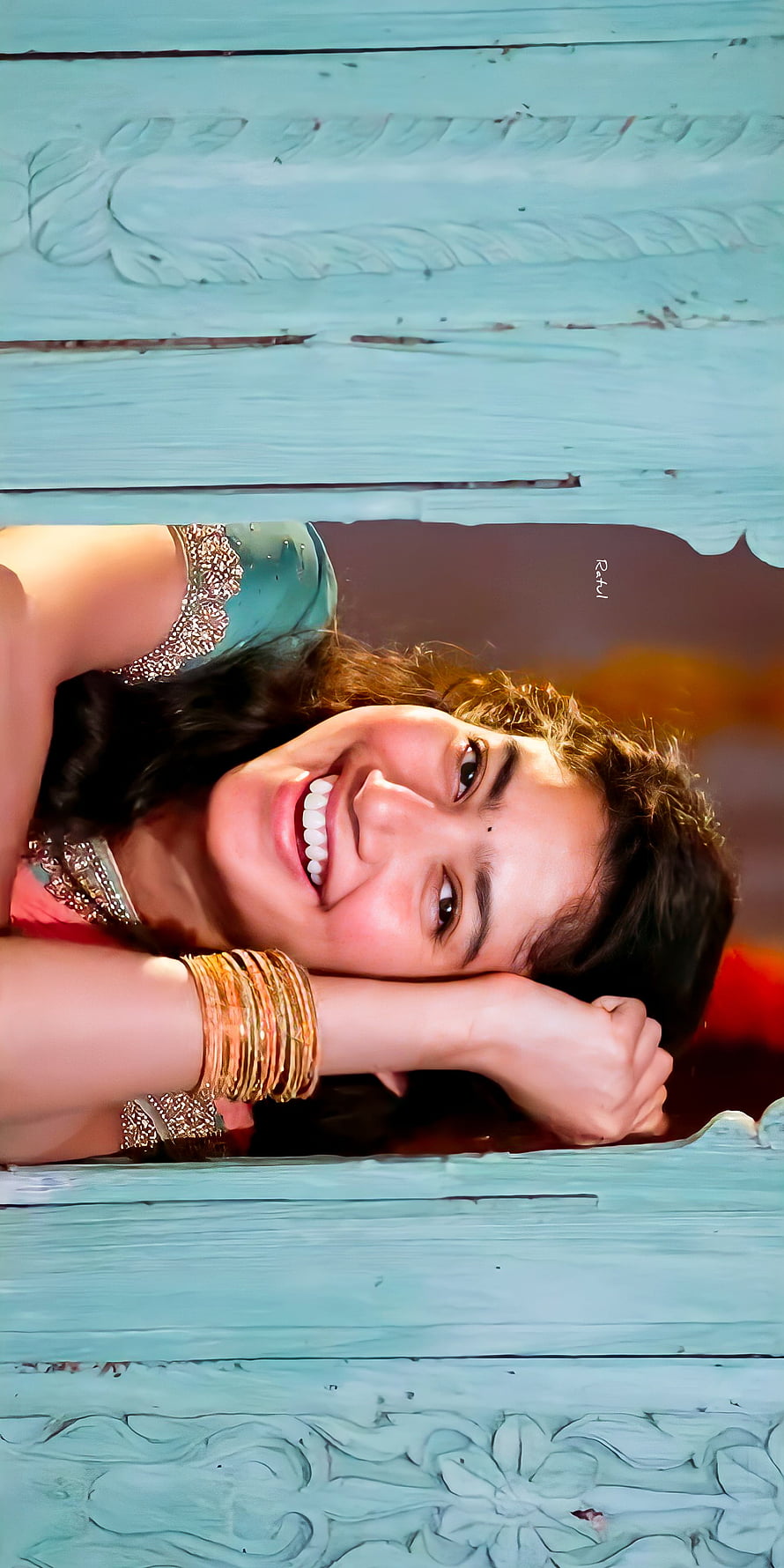 Sai Pallavi smiling portrait with traditional bangles and teal carved wooden frame HD phone wallpaper