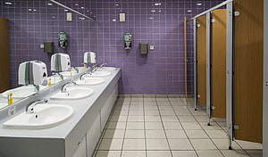 Modern Public Restroom Interior With Purple Tiled Walls And White Sinks HD wallpaper