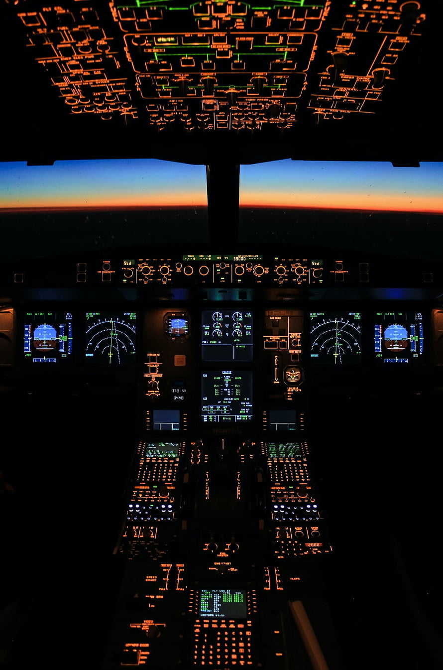 Airbus A350 Cockpit Interior at Sunset with Glowing Instrument Panels and Digital Displays HD phone wallpaper