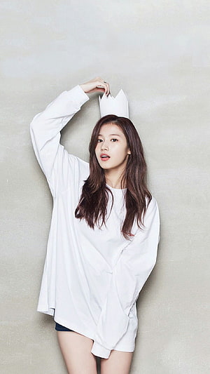 Sana Minatozaki in oversized white shirt with paper crown against neutral studio backdrop HD phone wallpaper