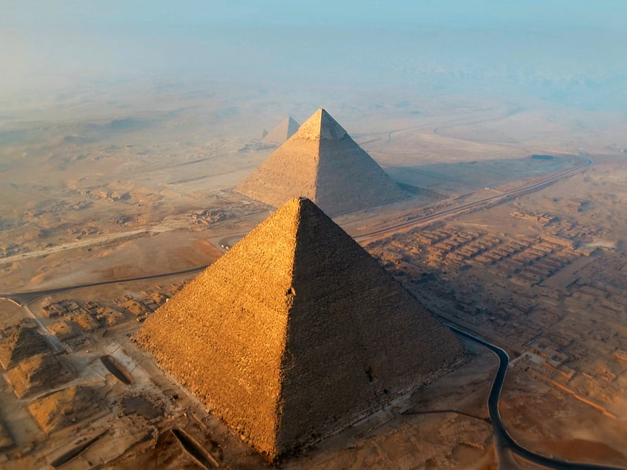 Aerial View of the Giza Pyramids at Golden Hour in the Egyptian Desert HD wallpaper