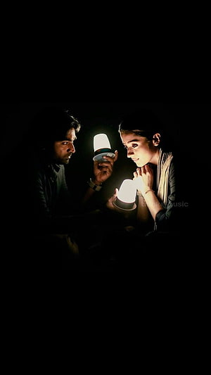 Vijay Sethupathi and Trisha Krishnan sharing a quiet moment with glowing lanterns in a dark cinematic scene HD phone wallpaper