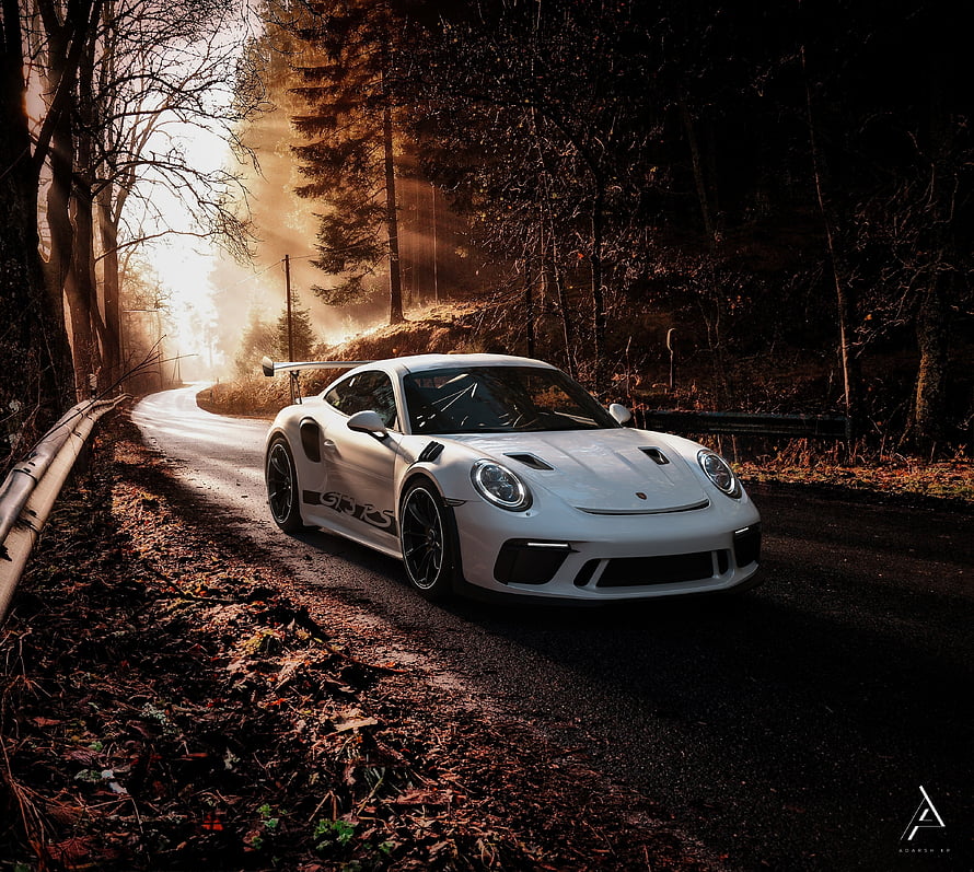 White Porsche 911 GT3 RS on a misty forest road at sunrise HD wallpaper