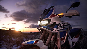Honda Africa Twin Adventure Motorcycle Parked on Rocky Ridge at Sunset HD wallpaper