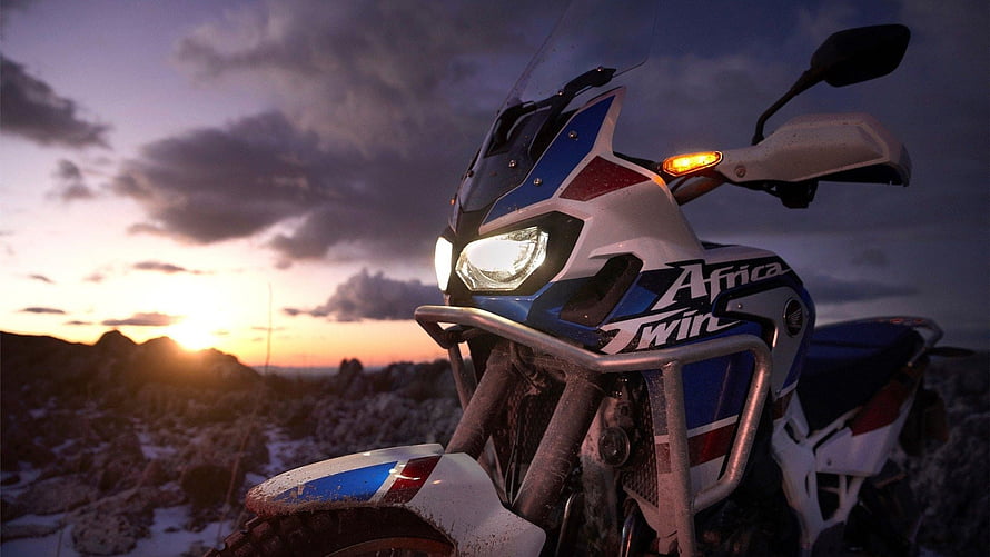 Honda Africa Twin Adventure Motorcycle Parked on Rocky Ridge at Sunset HD wallpaper