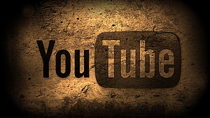 Grungy YouTube Logo on Textured Concrete Wall with Warm Sepia Lighting HD wallpaper