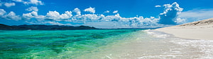 Turquoise Lagoon and White Sand Beach Under a Bright Blue Sky HD wallpaper