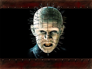 Pinhead from Hellraiser with a face of pins and a dark menacing expression HD wallpaper