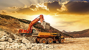 Heavy Excavator Loading Dump Truck in Open Pit Quarry at Golden Sunset HD wallpaper