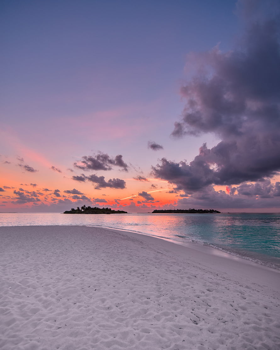 Tropical Island Beach at Sunset with Turquoise Water and Dramatic Clouds HD phone wallpaper