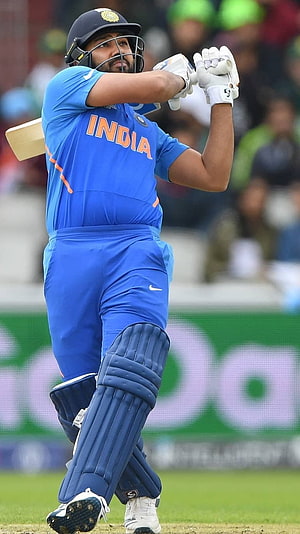 Rohit Sharma in India ODI kit mid-swing on a cricket field HD phone wallpaper