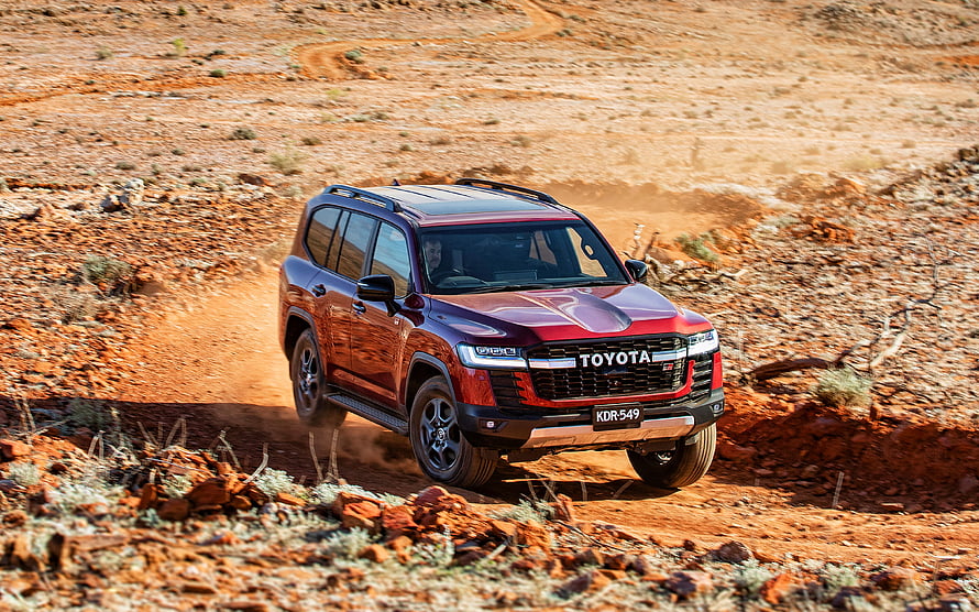 Red Toyota Land Cruiser GR Sport SUV Driving on Dusty Off-Road Desert Trail HD wallpaper