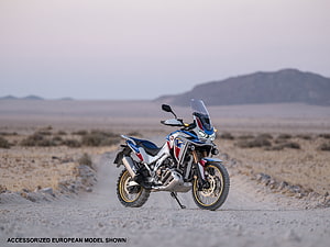 Honda CRF1100 Africa Twin Adventure Sports parked on a dusty desert trail at dusk HD wallpaper
