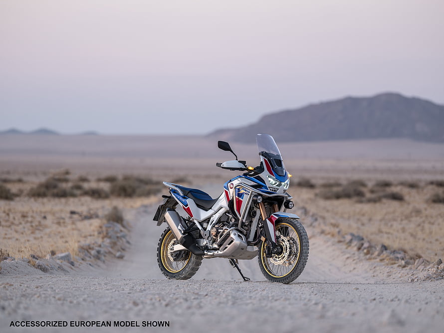 Honda CRF1100 Africa Twin Adventure Sports parked on a dusty desert trail at dusk HD wallpaper