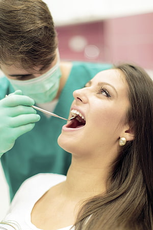 Dental Checkup: Dentist Examining Patient's Teeth with Mirror in Clinic HD phone wallpaper
