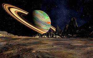 Alien Planet Surface With Ringed Gas Giant and Rocky Peaks in Deep Space HD wallpaper