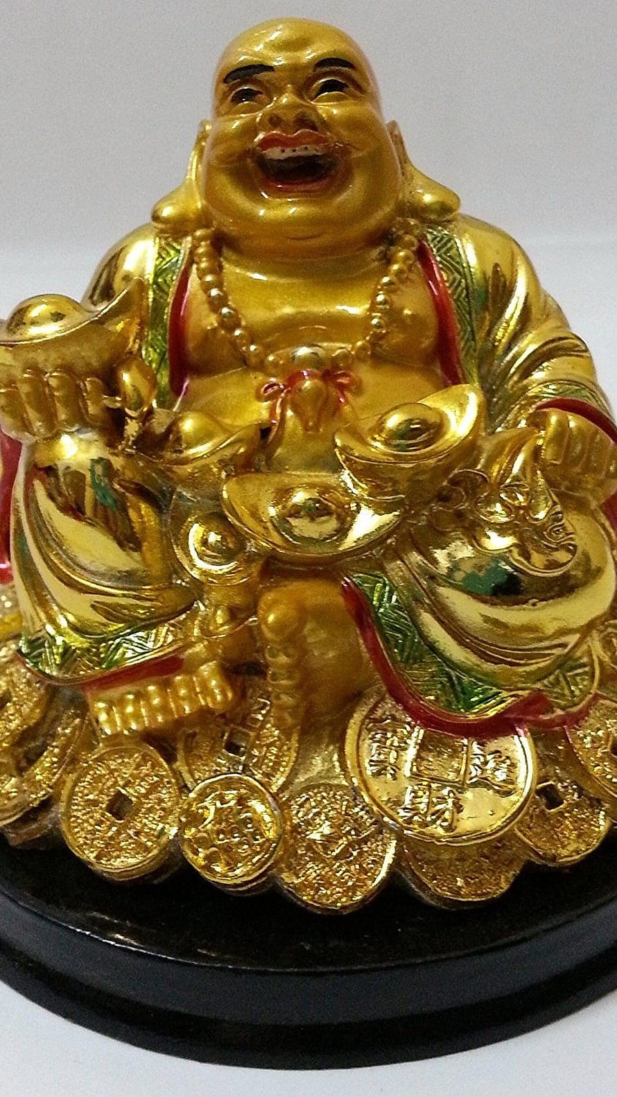 Golden Laughing Buddha Statue Surrounded by Coins and Ingot Symbols of Wealth HD phone wallpaper