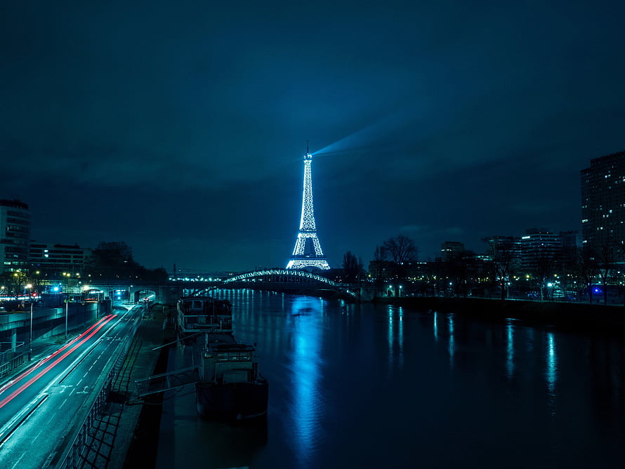 Eiffel Tower Illuminated at Night Over the Seine River in Paris HD wallpaper