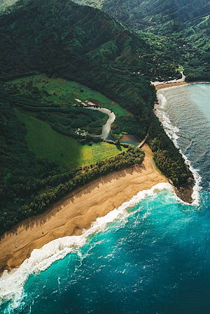 Aerial View of Turquoise Ocean Waves and Lush Green Valley in Kauai, Hawaii HD phone wallpaper