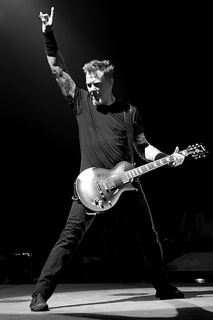 James Hetfield performing live on stage with electric guitar in black and white HD phone wallpaper