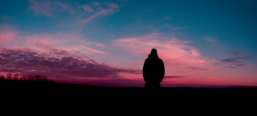 Lone Silhouette Standing Against Vibrant Pink and Blue Twilight Sky HD wallpaper