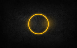 Glowing Yellow Neon Ring on Dark Textured Background HD wallpaper