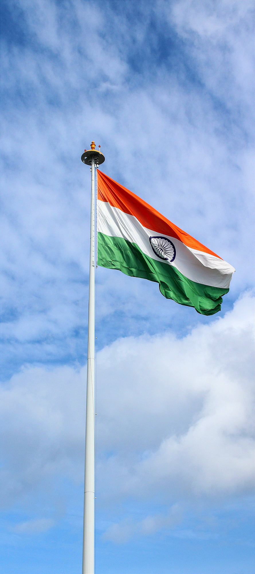 Indian National Flag Waving on a Tall Pole Against a Blue Sky with Clouds HD phone wallpaper