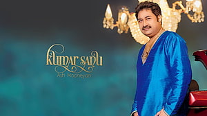 Kumar Sanu in a blue kurta with gold jewelry and chandelier backdrop HD wallpaper