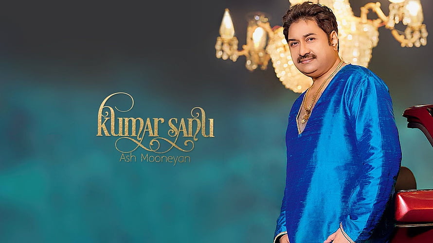 Kumar Sanu in a blue kurta with gold jewelry and chandelier backdrop HD wallpaper