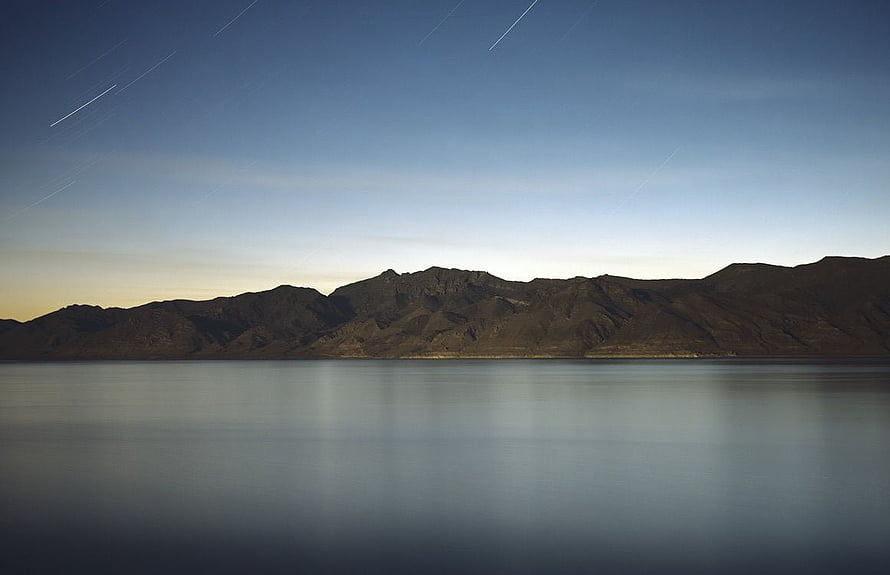 Serene Mountain Lake at Dusk with Star Trails in the Night Sky HD wallpaper
