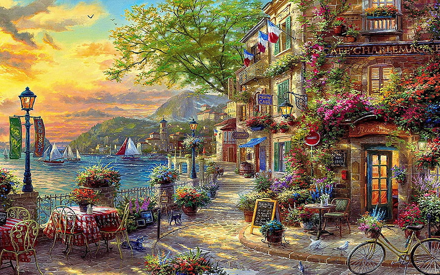 Charming French Riviera Cafe Scene with Flowering Buildings and Coastal Sunset HD wallpaper