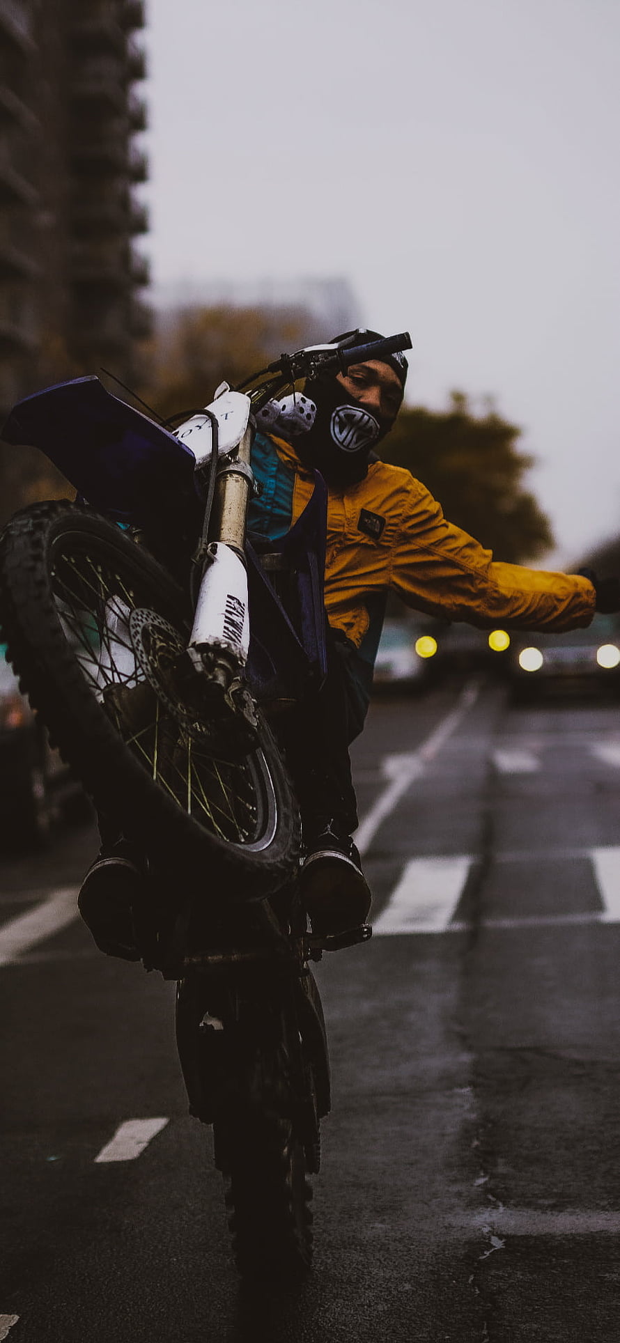 Urban Motorcycle Wheelie Stunt on Wet City Street at Dusk HD phone wallpaper