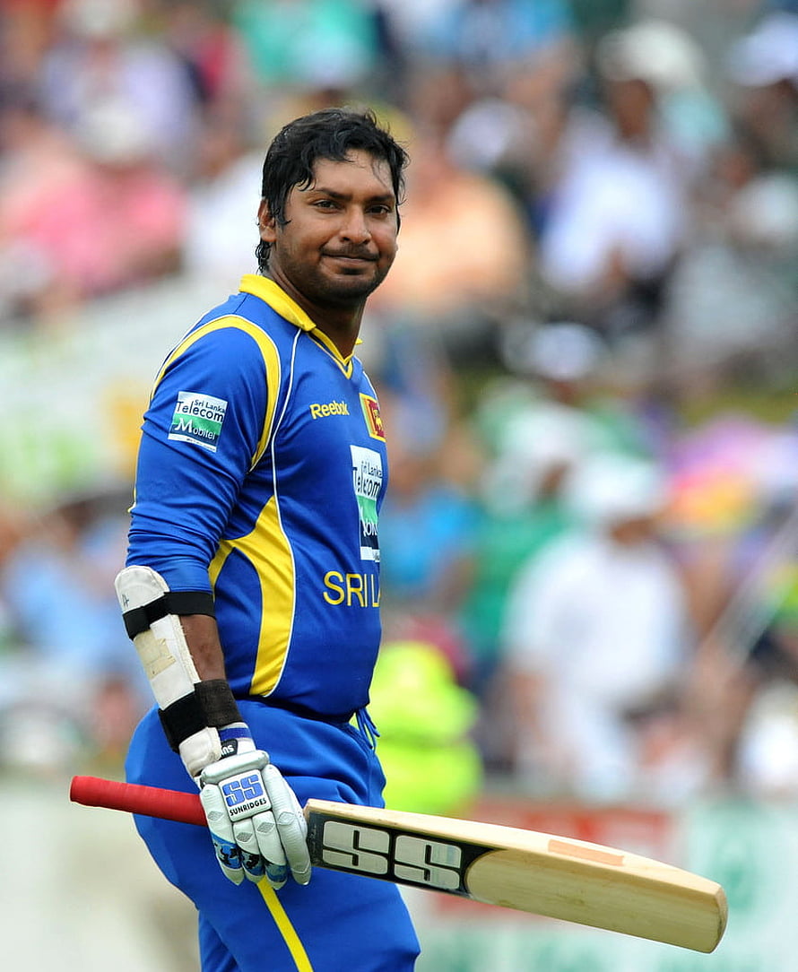 Kumar Sangakkara in Sri Lanka ODI kit holding SS cricket bat on the field HD phone wallpaper