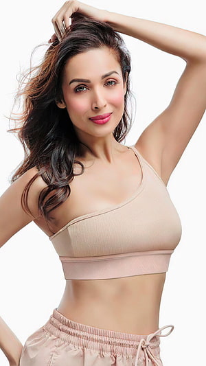 Malaika Arora in Nude Sportswear with Flowing Hair and Confident Pose HD phone wallpaper
