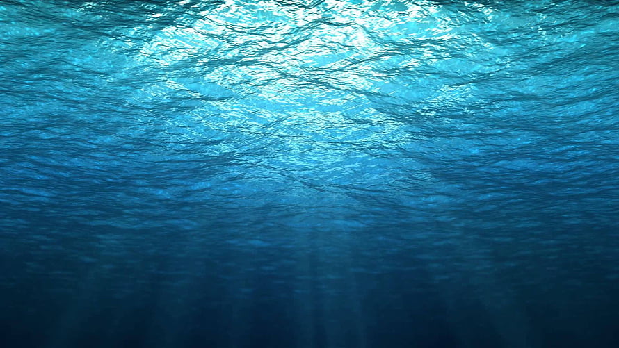 Sunlight Filtering Through Deep Blue Ocean Water Surface HD wallpaper