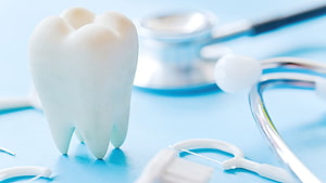 Dental Health Concept with Tooth Model and Stethoscope on Blue Background HD wallpaper