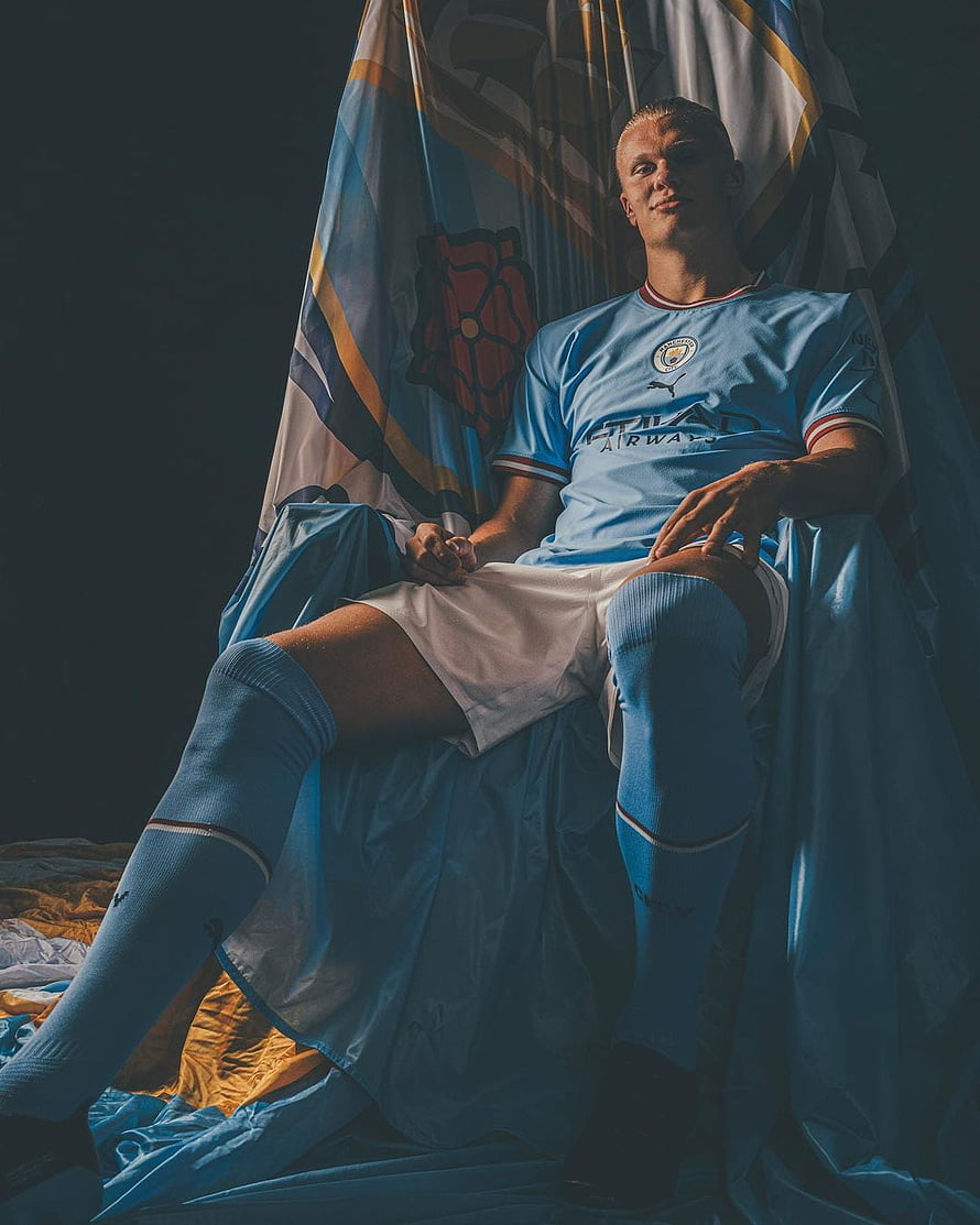 Erling Haaland in Manchester City Home Kit Seated on Throne with Team Flag HD phone wallpaper
