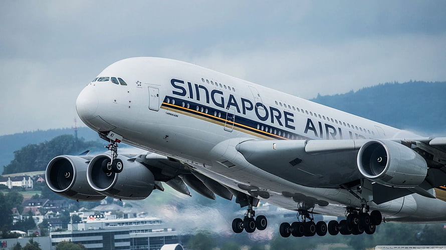 Singapore Airlines Airbus A380 taking off with landing gear deployed over a city HD wallpaper