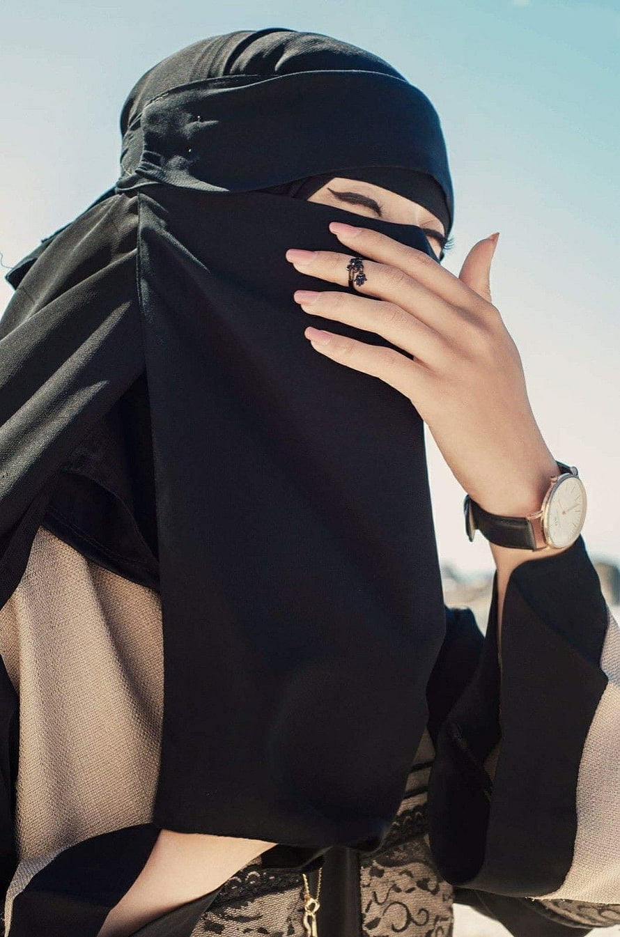 Elegant woman in black niqab with hand covering face against clear sky, Best Niqab Girls in 2020. Niqab, Niqab fashion, Hijab niqab, Cute Niqab HD phone wallpaper