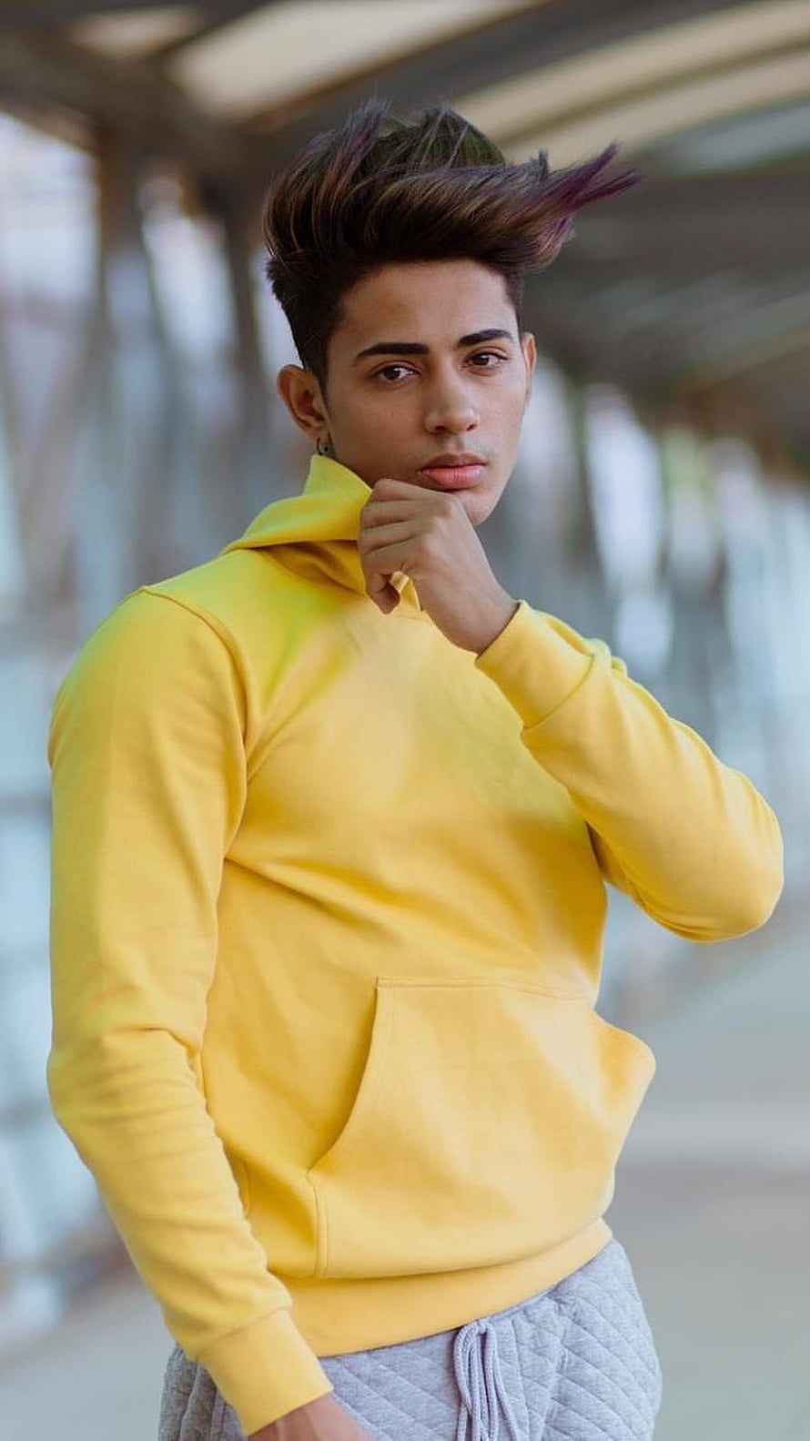 Danish Zehen in a bright yellow hoodie with a bold spiky hairstyle HD phone wallpaper