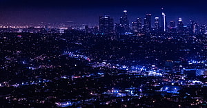 Aerial Night View of a Metropolitan City Skyline with Glowing Urban Lights HD wallpaper