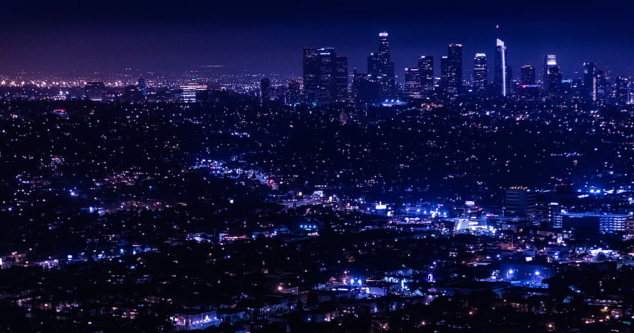 Aerial Night View of a Metropolitan City Skyline with Glowing Urban Lights HD wallpaper