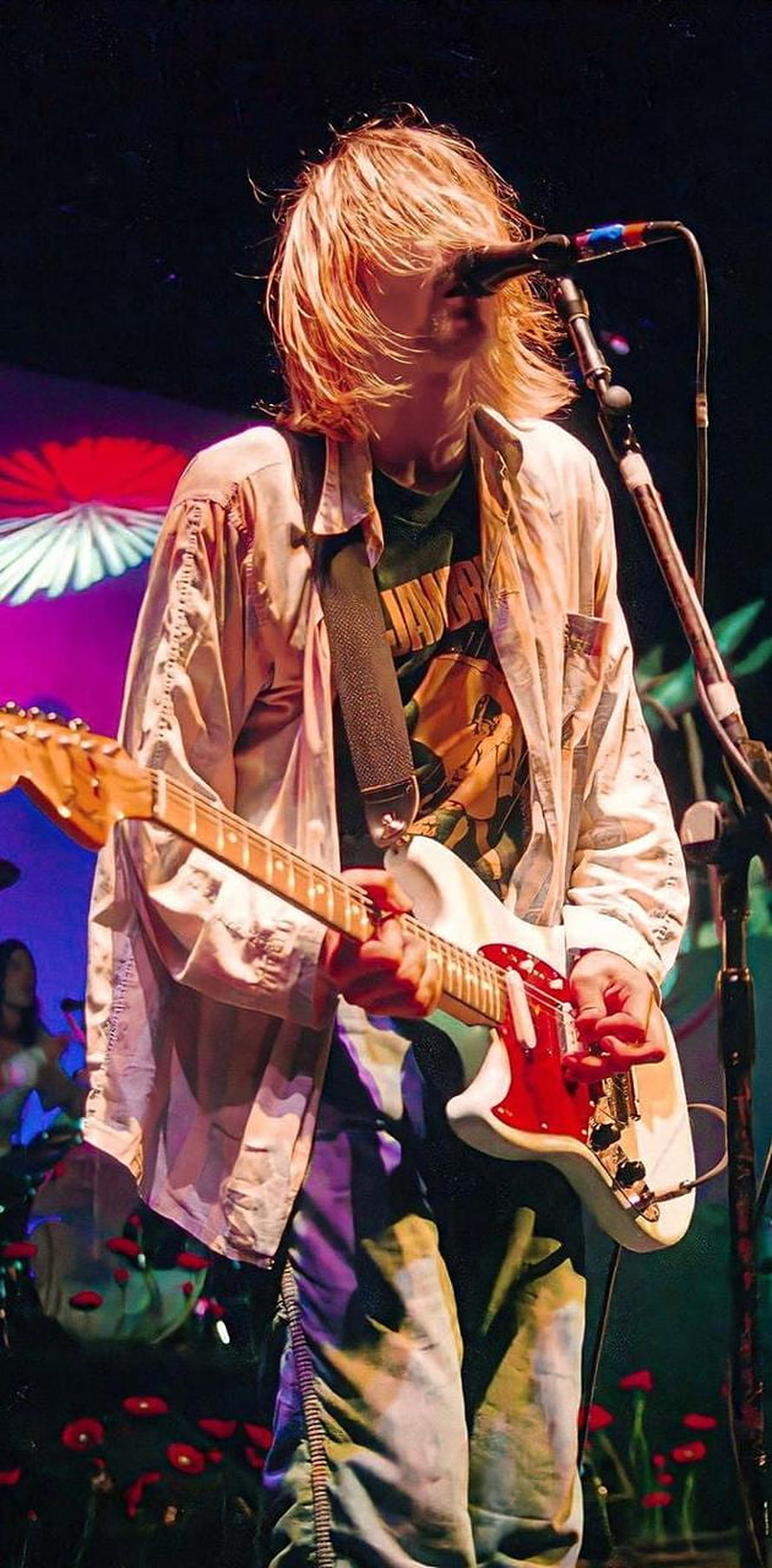 Kurt Cobain performing live on stage with a red electric guitar and microphone HD phone wallpaper